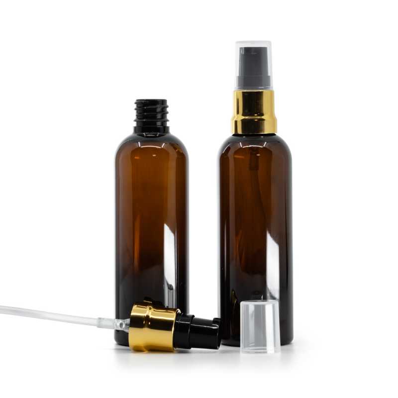 Barna műanyag palack, fényes fekete‑arany adagoló átlátszó kupakkal, 100 ml