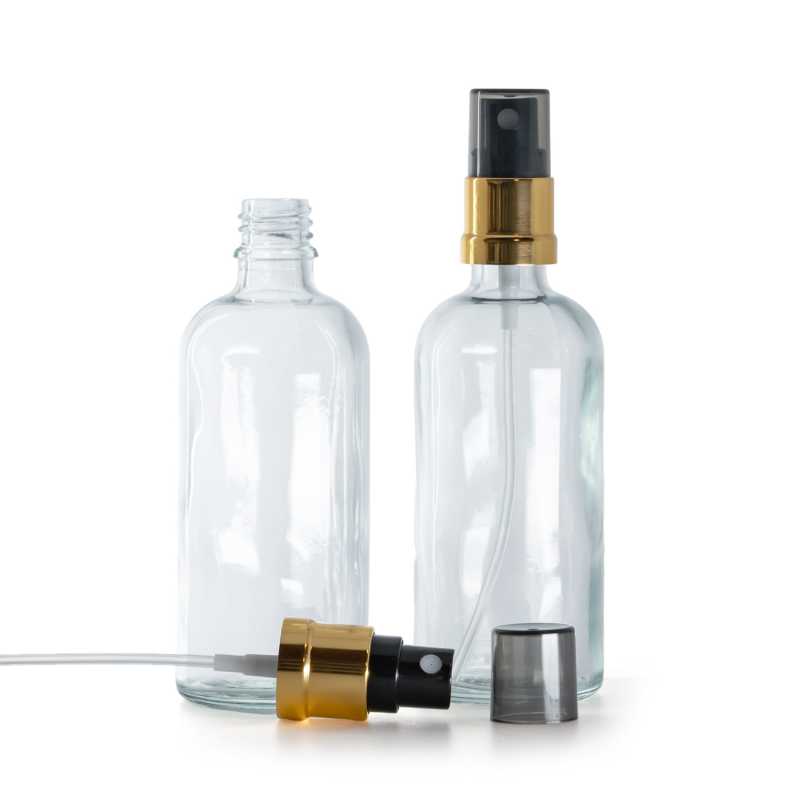 Átlátszó üvegpalack, fekete permetezőfej arany gallérral, füstszín kupak, 100 ml