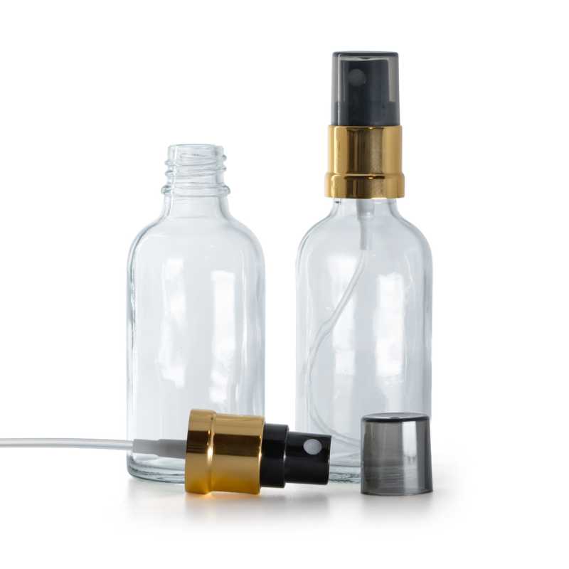 Átlátszó üvegpalack, fekete permetezőfej fényes arany gallérral, füstszínű kupak, 50 ml
