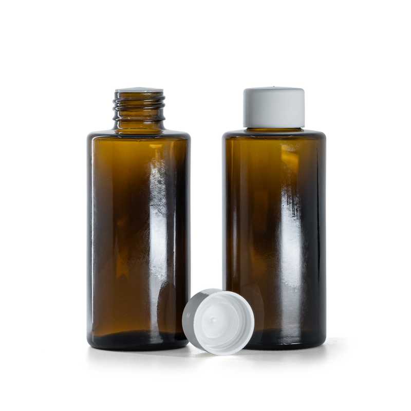 Borostyánszínű üvegpalack, egyenes nyak, 24 mm, sima fehér kupak betétadagolóval, 100 ml